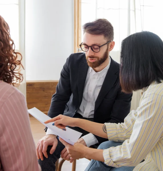 An experienced legal separation attorney in Orange County discussing financial documents and asset protection with clients.