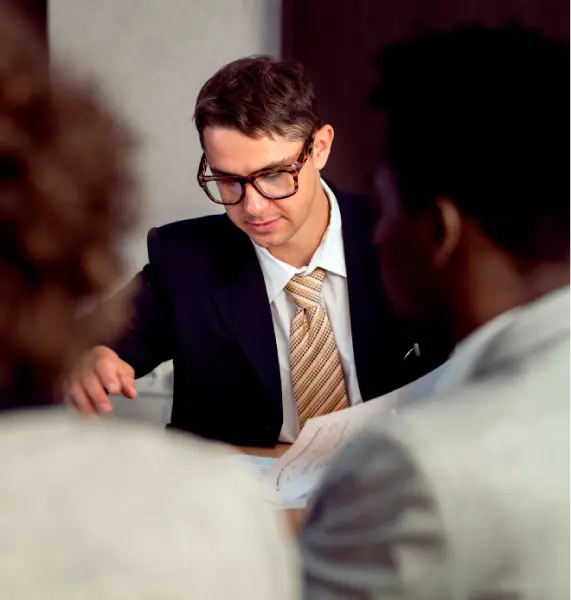An elite Orange County high-conflict divorce attorney carefully reviewing legal documents to protect a client’s assets and mental peace.